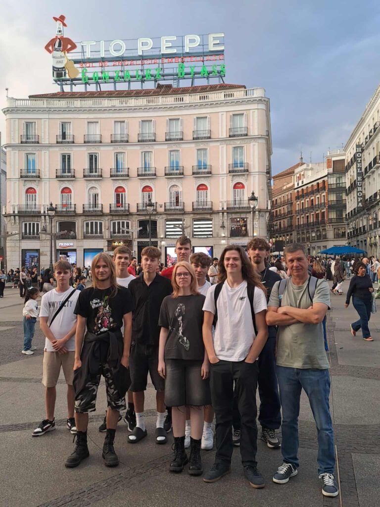 Osoby stojące przed budynkiem